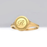 Custom gold initial ring for women with delicate alphabet engraving and sleek signet design