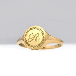 Custom gold initial ring for women with delicate alphabet engraving and sleek signet design