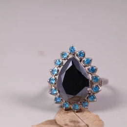 Art Deco style sterling silver pear shaped black onyx ring with blue topaz halo, cocktail statement ring, unique engagement gift