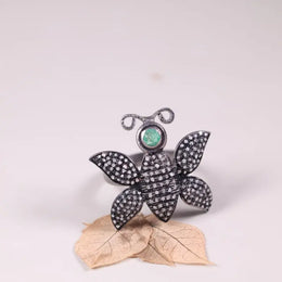 Victorian butterfly statement ring in silver with emerald and black diamond accents, gothic nature-inspired insect jewelry for women