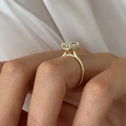 Oval 2 carat diamond engagement ring in white gold displayed on a hand with soft neutral manicure