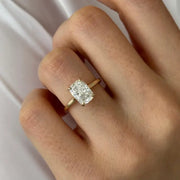 Oval 2 carat diamond engagement ring in white gold displayed on a hand with soft neutral manicure