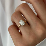 Oval 2 carat diamond engagement ring in white gold displayed on a hand with soft neutral manicure