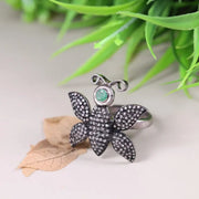 Victorian butterfly statement ring in silver with emerald and black diamond accents, gothic nature-inspired insect jewelry for women