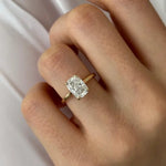 Oval 2 carat diamond engagement ring in white gold displayed on a hand with soft neutral manicure