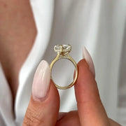 Oval 2 carat diamond  engagement ring in white gold displayed on a hand with soft neutral manicure