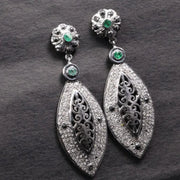 Victorian style silver filigree dangle earrings with emerald and black diamond accents, handmade statement jewelry gift.