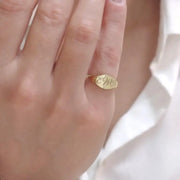 Personalized gold alphabet ring for women featuring dainty initial design in a modern signet style