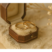 Matching diamond-studded couple rings for a luxurious and romantic bond.