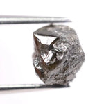 Natural black diamond ring featuring a faceted stone in a rose gold 