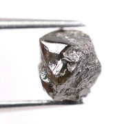 Natural black diamond ring featuring a faceted stone in a rose gold 