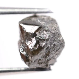 Natural black diamond ring featuring a faceted stone in a rose gold 