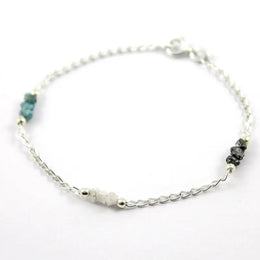 bracelet gold and solid gold bracelet with blue diamond uncut and luxury jewelry display.