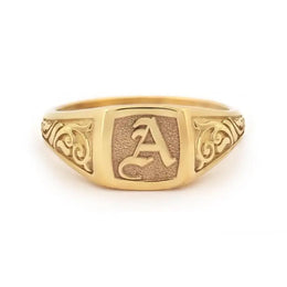 Elegant dainty gold initial ring with custom alphabet engraving in a sleek and stylish signet design
