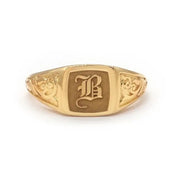 Elegant dainty gold initial ring with custom alphabet engraving in a sleek and stylish signet design
