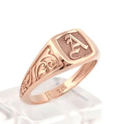 Elegant dainty gold initial ring with custom alphabet engraving in a sleek and stylish signet design