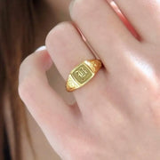 Elegant dainty gold initial ring with custom alphabet engraving in a sleek and stylish signet design