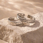 Silver couple rings with engraved date, personalized memory of love.