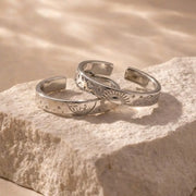 Silver couple rings with engraved date, personalized memory of love.