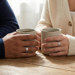 Silver couple rings with engraved date, personalized memory of love.