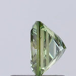 vivid green colour diamond princess cut green lab grown diamond with sharp facets on a light gray background.