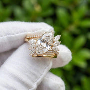 Marquise cut diamond ring with floral side stones in yellow gold