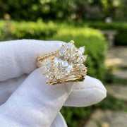 Marquise cut diamond ring with floral side stones in yellow gold