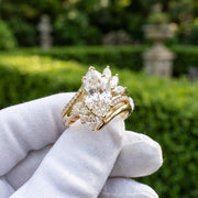 Marquise cut diamond ring with floral side stones in yellow gold
