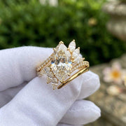 Marquise cut diamond ring with floral side stones in yellow gold