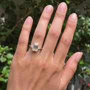 3 stone emerald engagement ring with elegant diamond setting