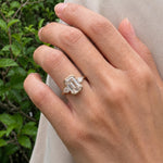 3 stone emerald engagement ring with elegant diamond setting