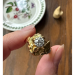 Elongated round cut engagement ring in yellow gold
