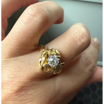 Elongated round cut engagement ring in yellow gold