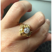 Elongated round cut engagement ring in yellow gold