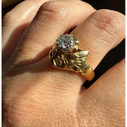 Elongated round cut engagement ring in yellow gold