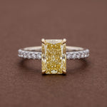 yellow radiant cut diamond ring with pave diamond band 