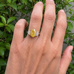 yellow oval cut diamond ring with baguette side stones in gold