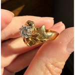 Elongated round cut engagement ring in yellow gold