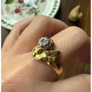 Elongated round cut engagement ring in yellow gold