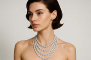 Woman wearing a diamond necklace on a plain background